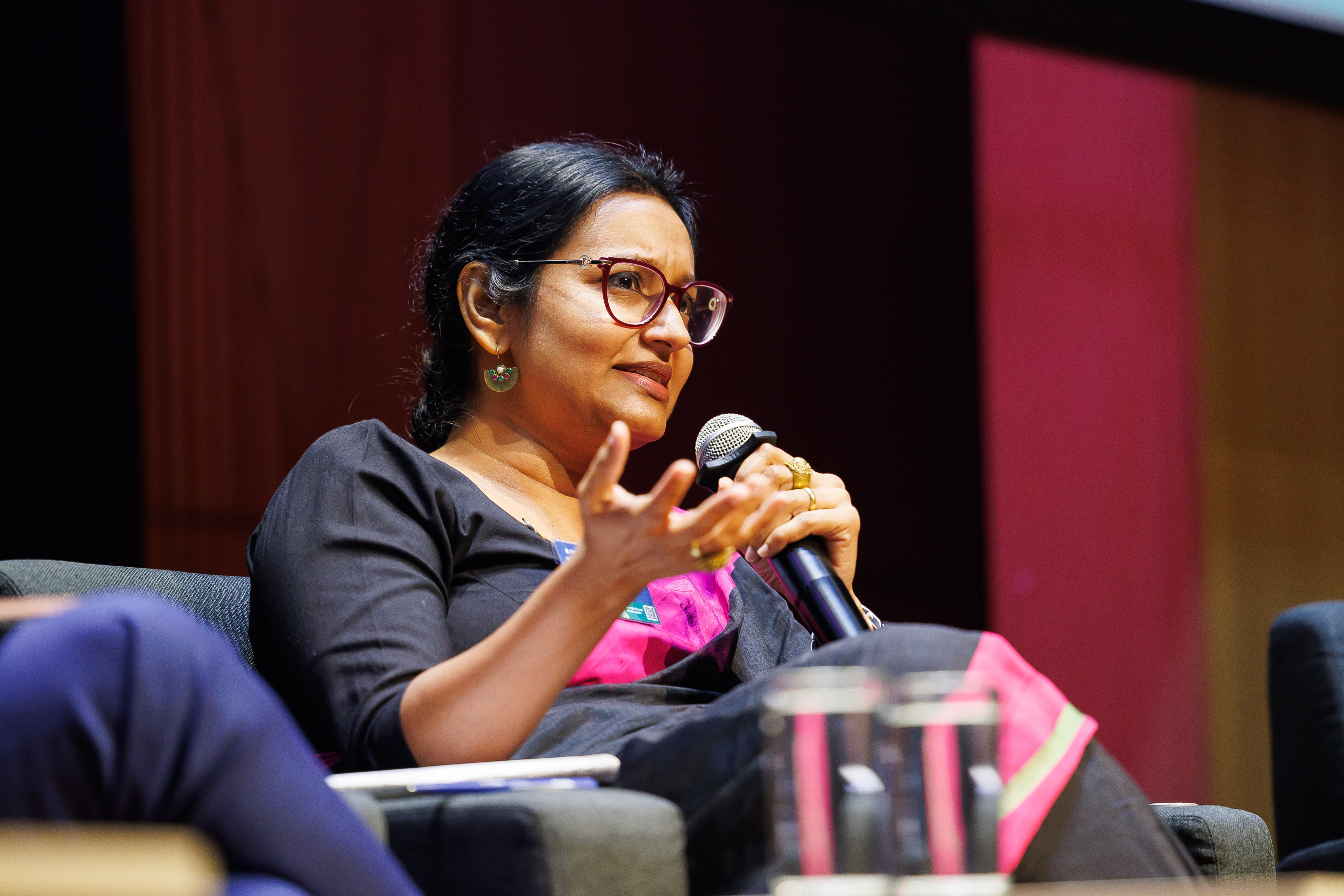 woman address crowd during panel 