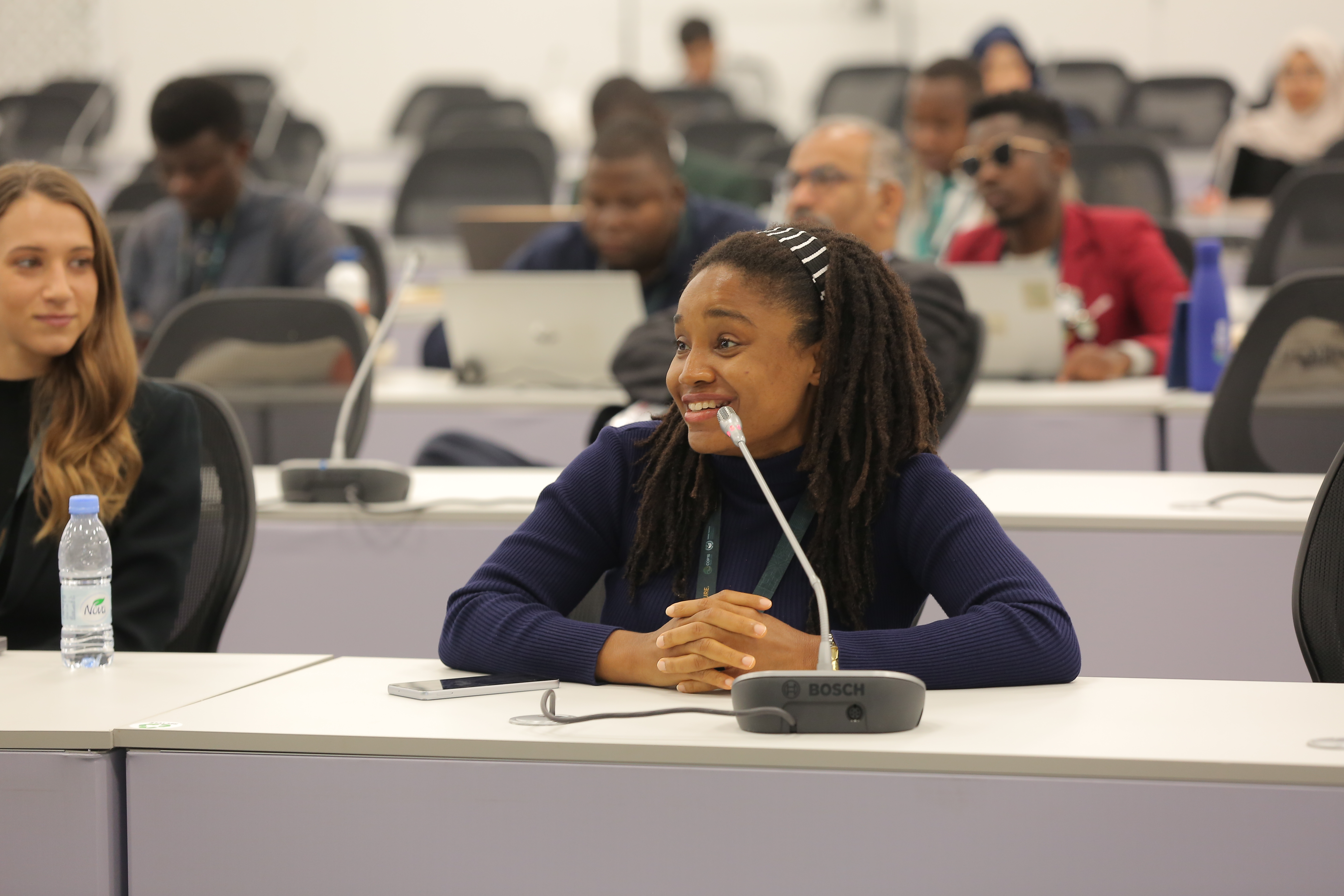 young person speaking at microphone