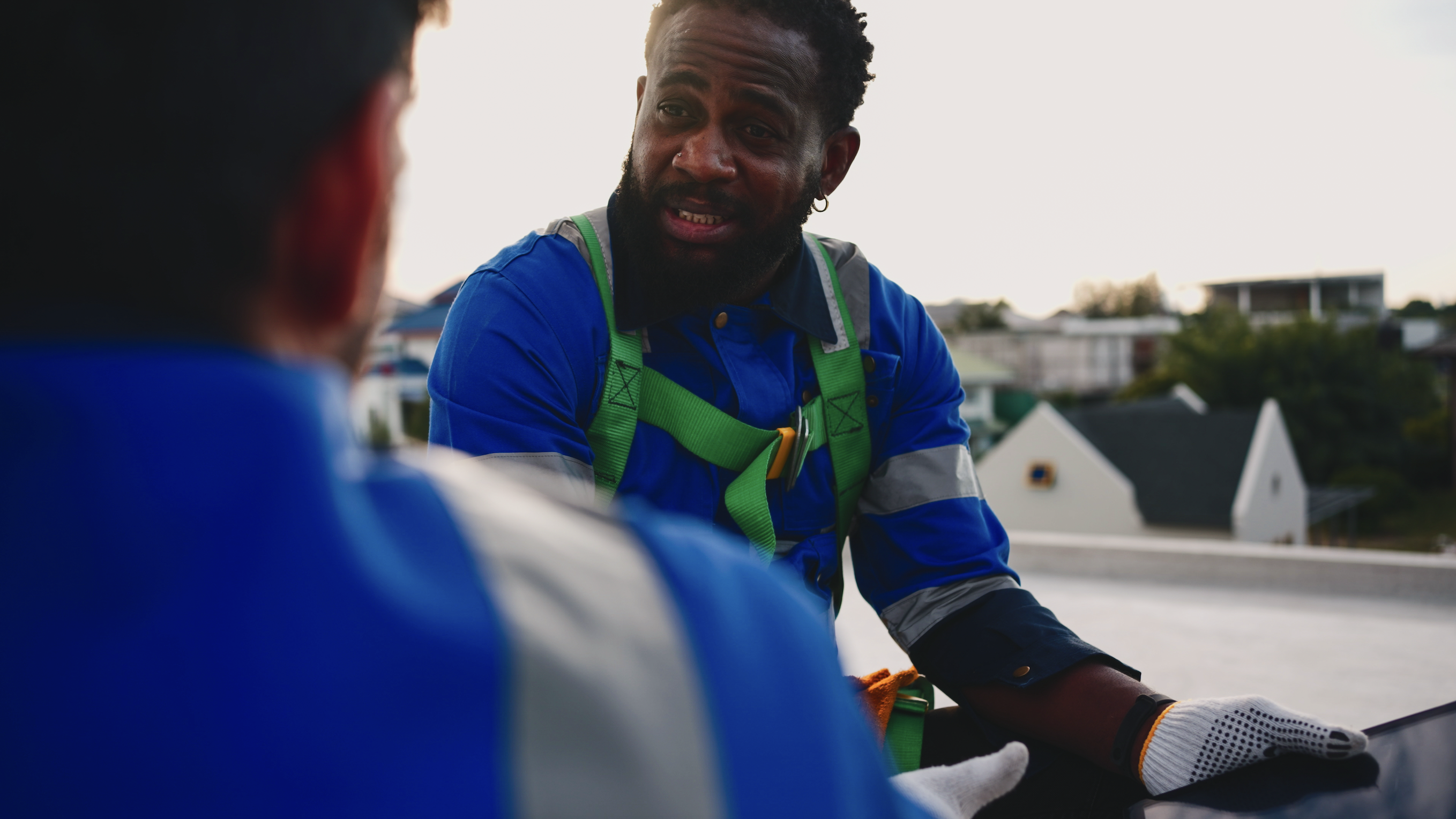 Man talking to another man outside while working
