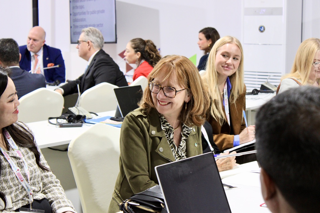 Group of people sitting at tables at COSP11