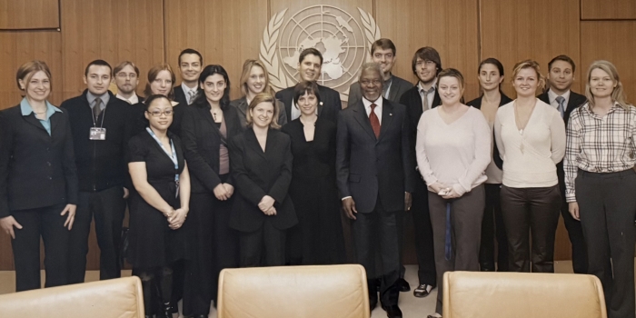 people standing behind the UN logo 