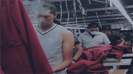 man steaming clothes in factory