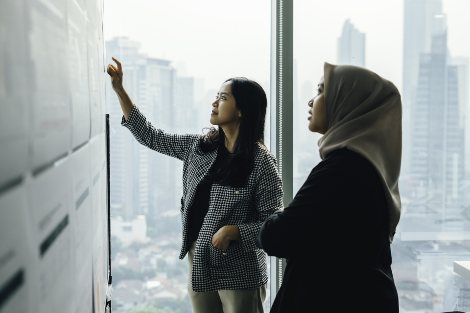 Women looking at a schedule