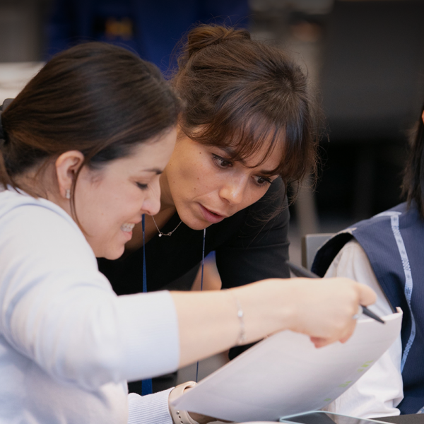 UN Global Compact Hub Cover, Two women employees reading a document