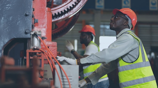 The image shows two male construction workers.