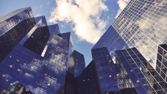 building with the sky's reflection in its windows