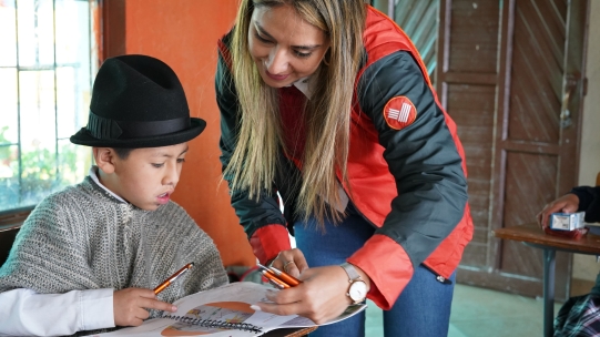 woman helping child with work